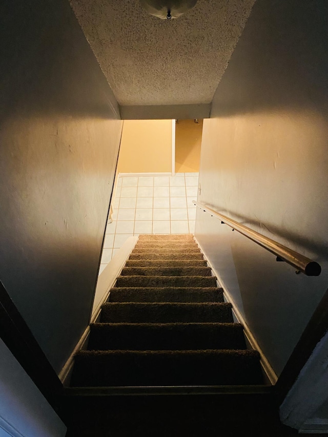 stairs with tile patterned floors