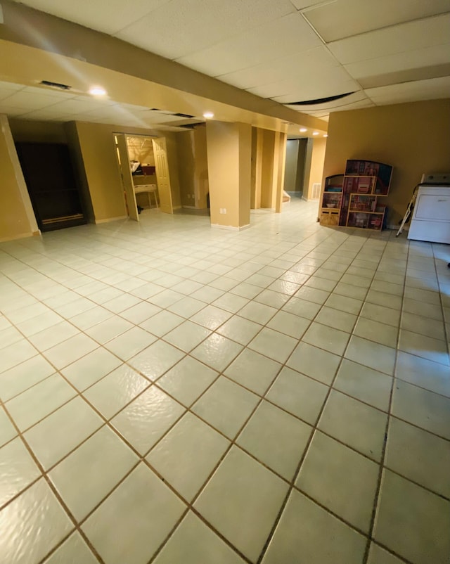 basement with light tile patterned flooring and washer / clothes dryer