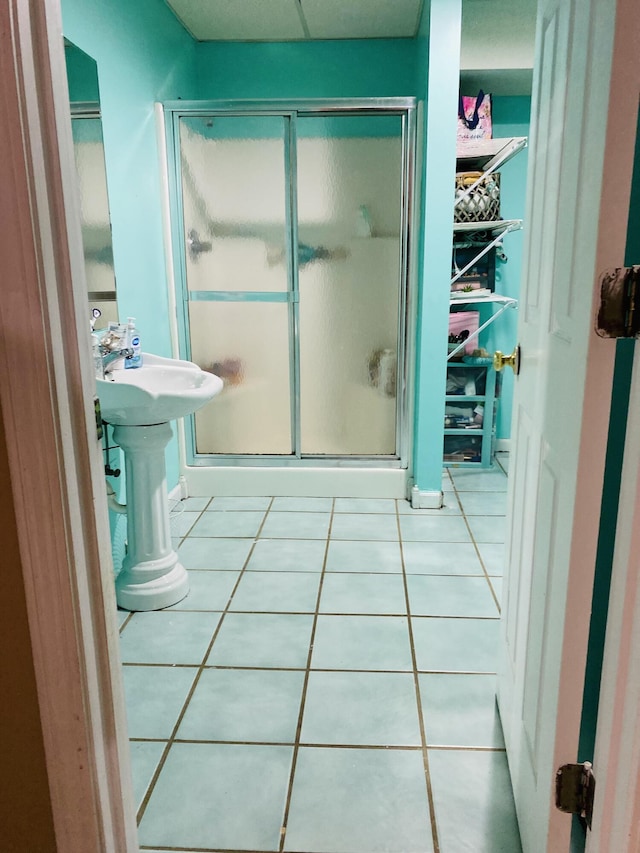 bathroom featuring tile patterned floors and a shower with shower door