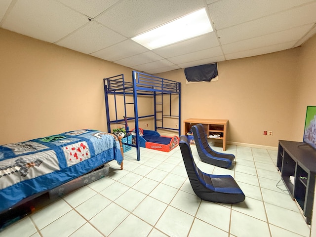 tiled bedroom featuring a drop ceiling