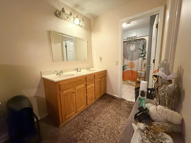 bathroom featuring tile patterned flooring, a textured ceiling, and vanity