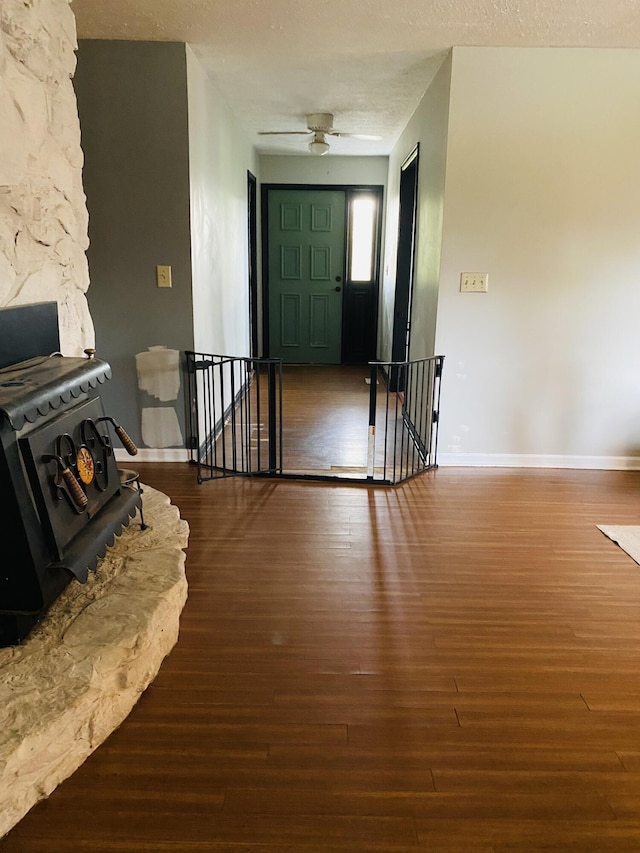 entrance foyer with a textured ceiling, ceiling fan, and dark hardwood / wood-style floors