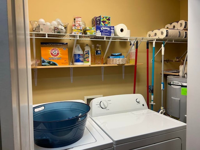 washroom featuring electric water heater and independent washer and dryer