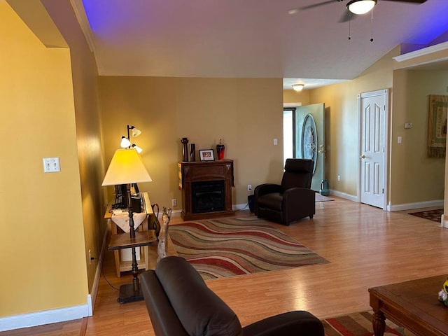 living room with lofted ceiling, light hardwood / wood-style flooring, and ceiling fan