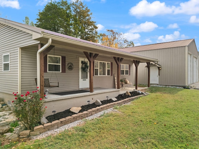 single story home featuring covered porch and a front lawn