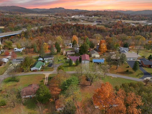 aerial view at dusk featuring a mountain view