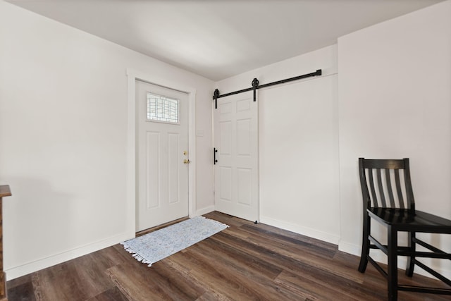 foyer featuring a barn door and dark hardwood / wood-style flooring