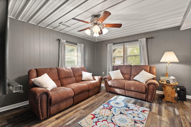 living room featuring wood walls, ceiling fan, and dark hardwood / wood-style flooring