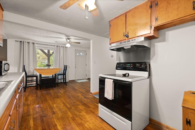 kitchen featuring white range with electric cooktop, ceiling fan, and dark hardwood / wood-style flooring