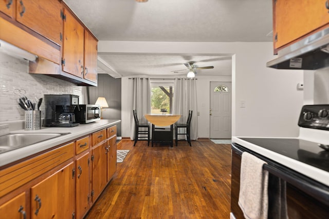 kitchen featuring exhaust hood, dark hardwood / wood-style flooring, ceiling fan, backsplash, and white range with electric cooktop