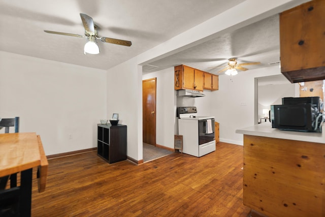 kitchen featuring dark wood-type flooring, electric stove, and ceiling fan