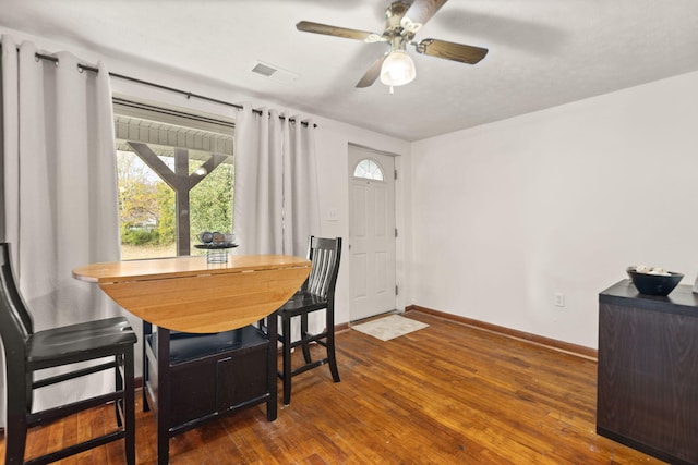 dining area with dark hardwood / wood-style floors and ceiling fan