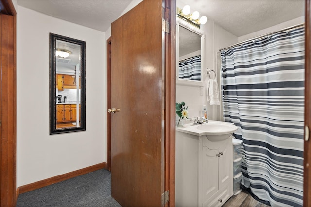 bathroom featuring vanity, a textured ceiling, toilet, and hardwood / wood-style floors