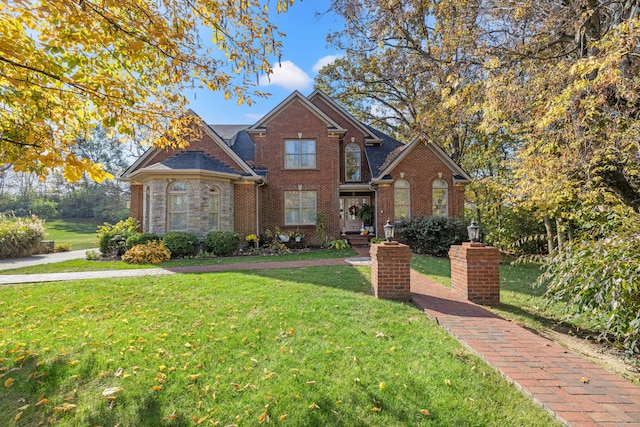 view of property featuring a front lawn