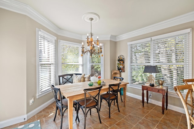 dining space featuring a chandelier, ornamental molding, and plenty of natural light