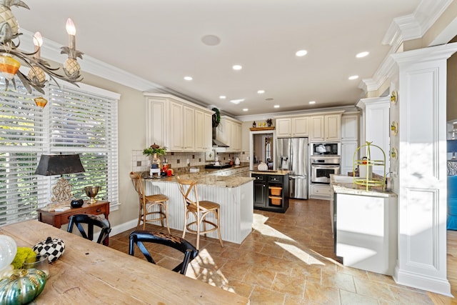 kitchen featuring light stone counters, decorative backsplash, kitchen peninsula, crown molding, and appliances with stainless steel finishes