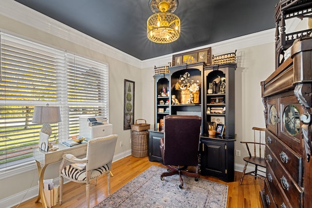 home office featuring light wood-type flooring and crown molding