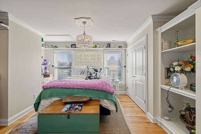 bedroom featuring hardwood / wood-style flooring, a chandelier, and ornamental molding