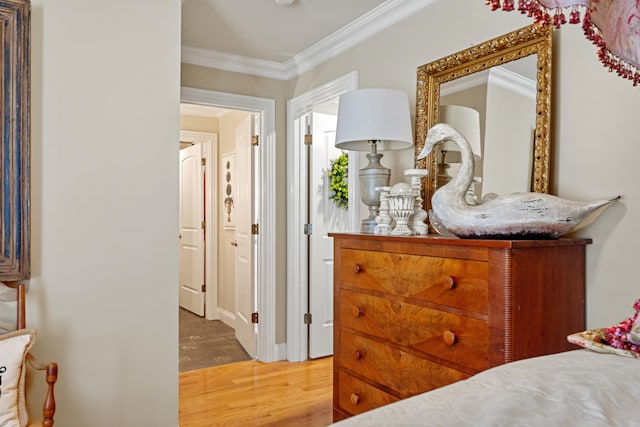 bedroom featuring wood-type flooring and ornamental molding