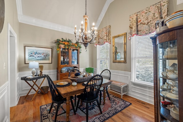 dining room with light hardwood / wood-style flooring, a chandelier, and crown molding