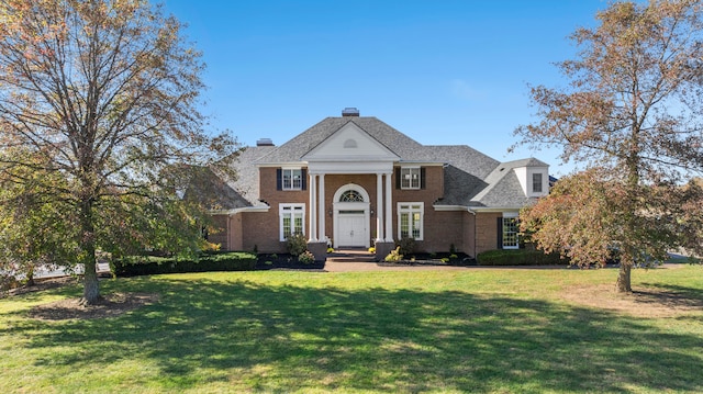 greek revival house with a front lawn