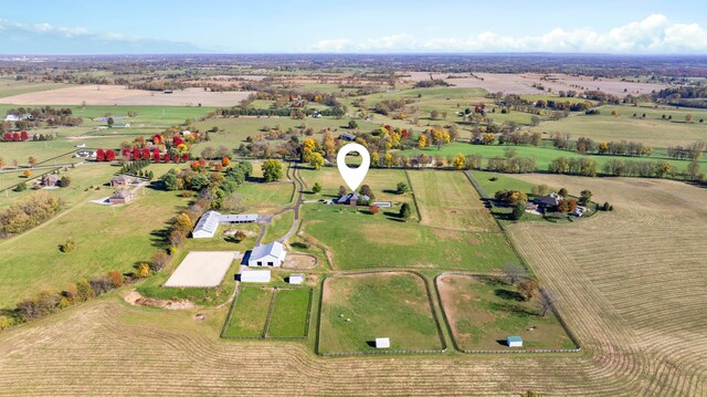 birds eye view of property with a rural view