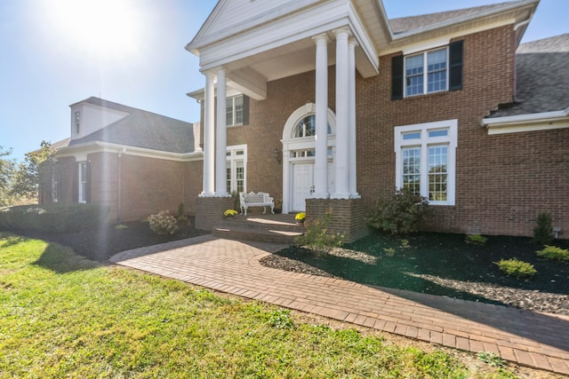 doorway to property featuring a yard