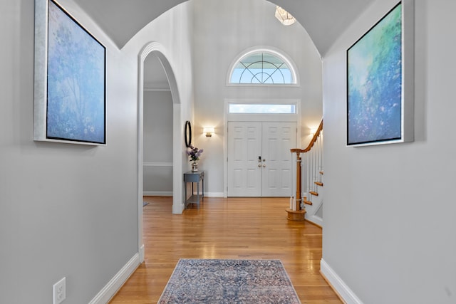 entrance foyer with light hardwood / wood-style flooring and vaulted ceiling