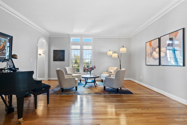 sitting room with crown molding and hardwood / wood-style floors