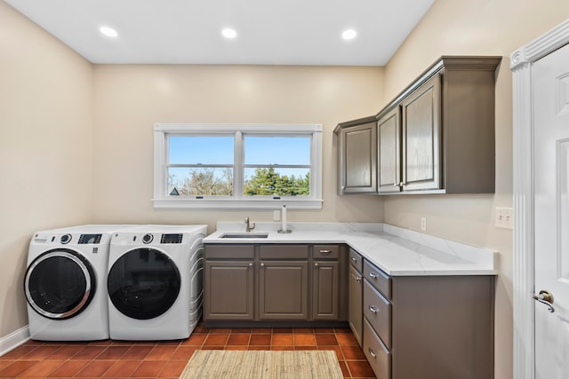 washroom featuring sink, cabinets, separate washer and dryer, and dark tile patterned floors