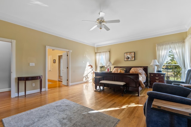 bedroom with ornamental molding, light hardwood / wood-style floors, and ceiling fan