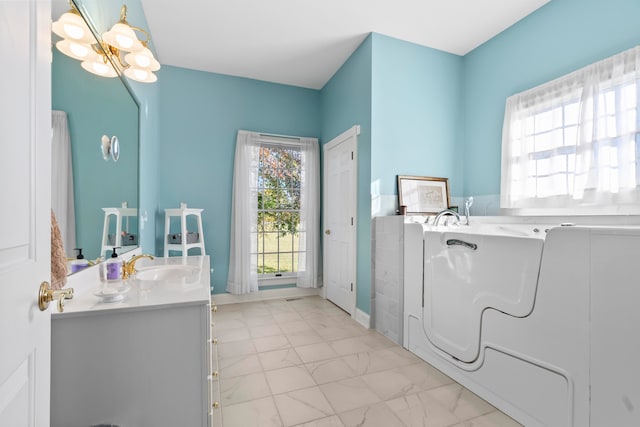 bathroom with vanity and a bath