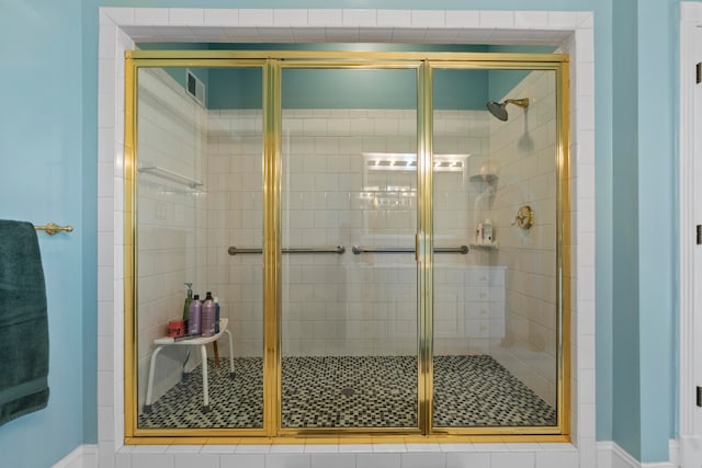 bathroom with a shower with shower door