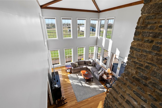 living room with high vaulted ceiling, beamed ceiling, and hardwood / wood-style floors