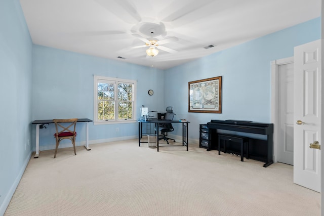 home office featuring light carpet and ceiling fan