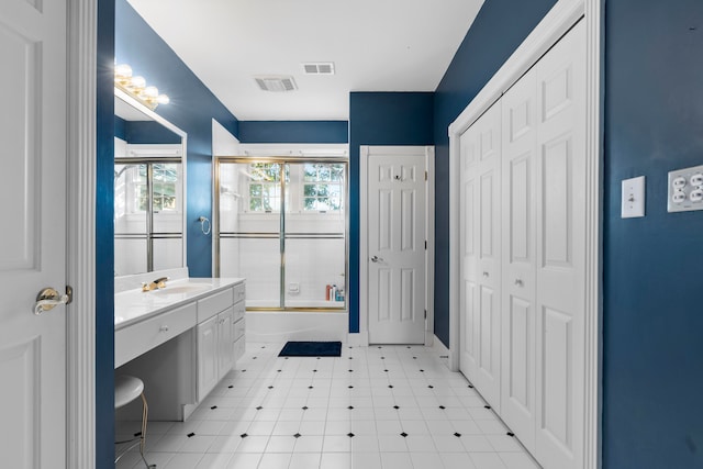 bathroom with vanity and enclosed tub / shower combo