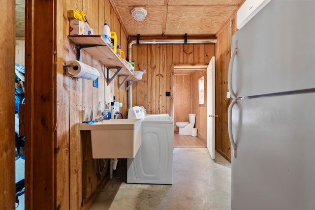 washroom featuring sink, wood ceiling, and wood walls