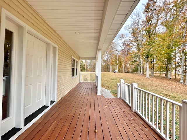 wooden terrace with a yard