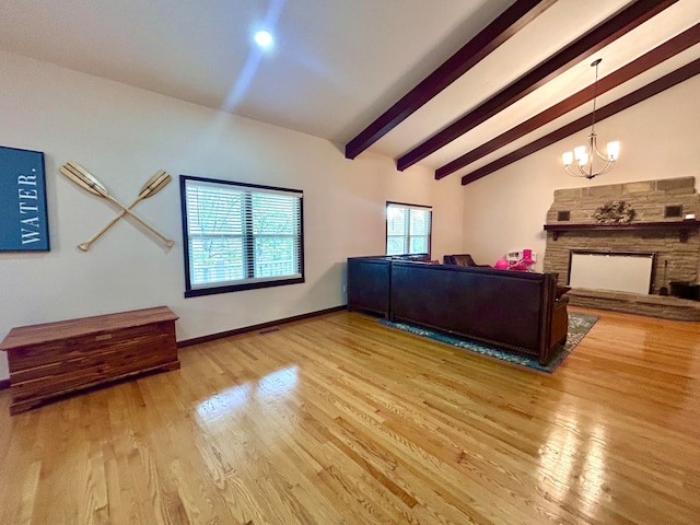 living room with a stone fireplace, a chandelier, light wood-type flooring, and lofted ceiling with beams