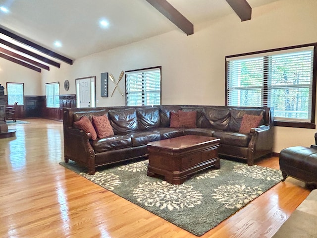 living room featuring hardwood / wood-style floors and vaulted ceiling with beams