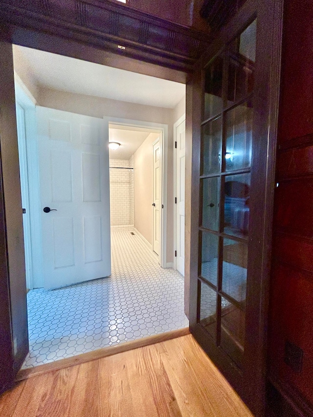 hall featuring tile patterned flooring