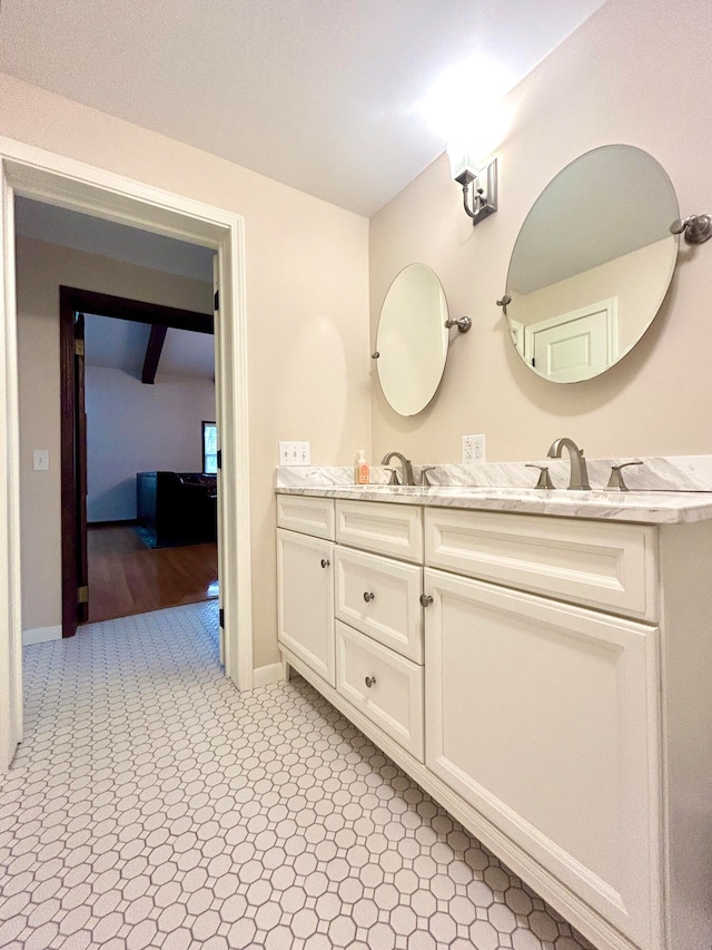 bathroom with vanity, beam ceiling, and wood-type flooring