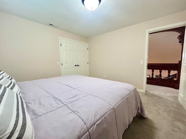 bedroom featuring light carpet and a closet