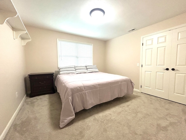 carpeted bedroom featuring a closet