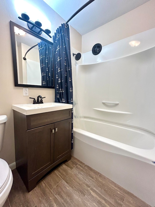 full bathroom with shower / bath combo, wood-type flooring, vanity, and toilet