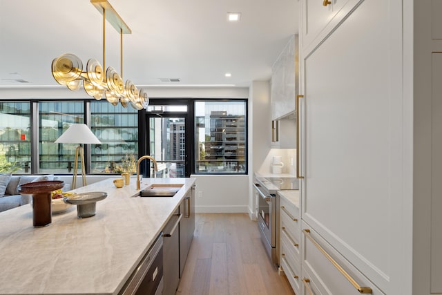 106 W Vine St Unit 407, Lexington, KY 40507 - kitchen with a sink, electric stove, light wood finished floors, white cabinetry, and pendant lighting