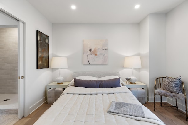 106 W Vine St Unit 407, Lexington, KY 40507 - bedroom with wood finished floors, baseboards, and recessed lighting