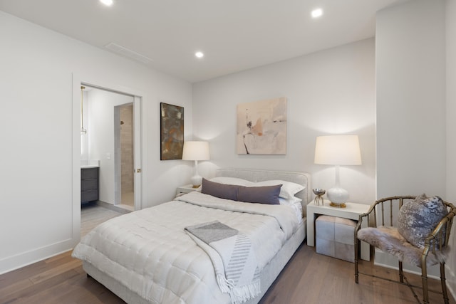 106 W Vine St Unit 407, Lexington, KY 40507 - bedroom featuring wood finished floors, recessed lighting, baseboards, and ensuite bathroom