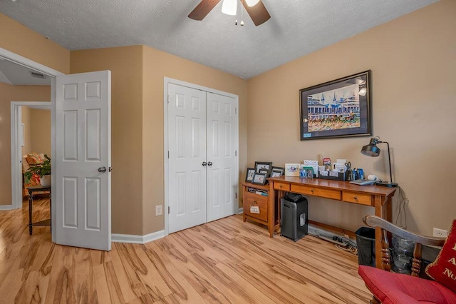 office area with ceiling fan, a textured ceiling, and light wood-type flooring