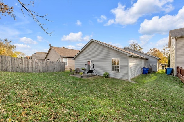 back of house with a yard and a patio area